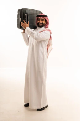 Saudi Man in Traditional Thobe Carrying Suitcase