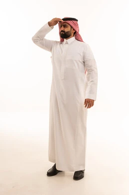 Saudi Man in Traditional Thobe Looking into the Distance