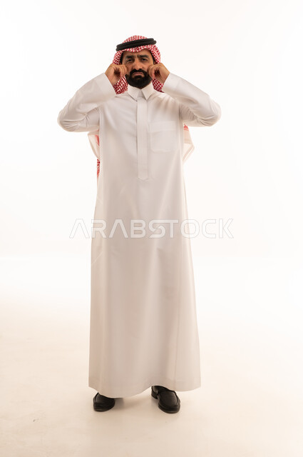 Saudi Man in Thobe Pulling Cheeks on White Background
