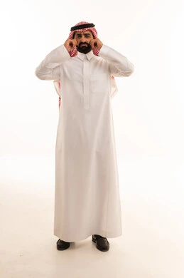 Saudi Man in Thobe Pulling Cheeks on White Background