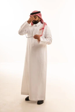 Saudi Man in Thobe Rubbing Eyes with Fatigue