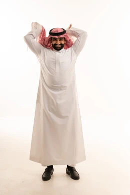 Saudi Man in Traditional Thobe Adjusting Shemagh