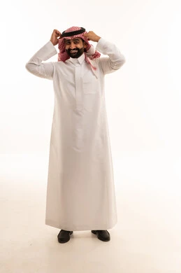 Saudi Man in Traditional Thobe Adjusting Agal