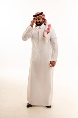 Saudi Man in Thobe Rubbing Eyes from Fatigue