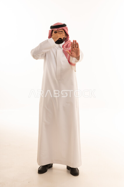 Saudi Man in Traditional Thobe Making Stop Gesture
