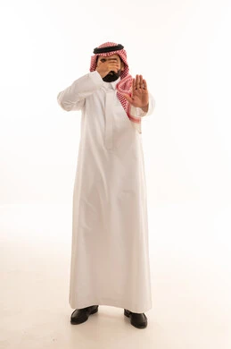 Saudi Man in Traditional Thobe Making Stop Gesture