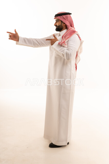 Saudi Man in Traditional Thobe Pointing Side View