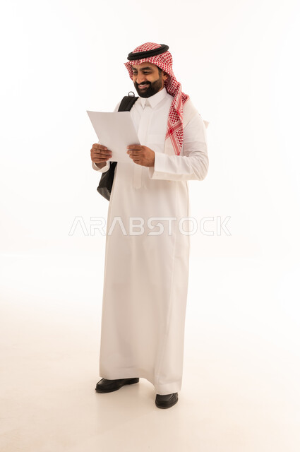 Saudi Businessman in Thobe Holding Document