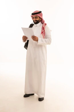 Saudi Businessman in Thobe Holding Document