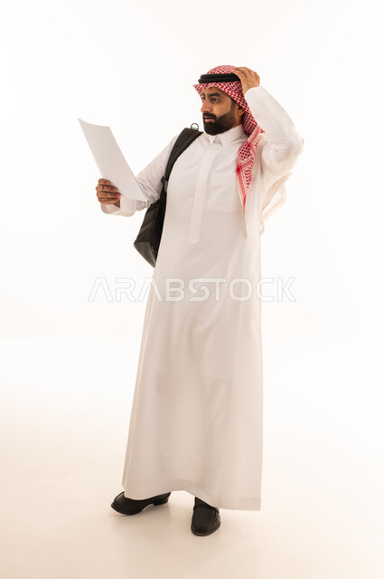 Saudi Man Holding Paper with Confused Expression