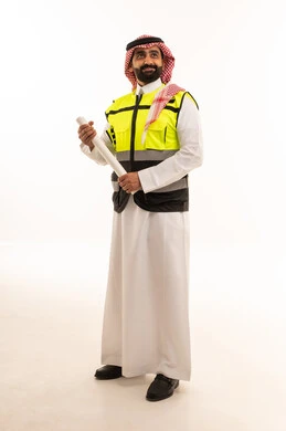Saudi Engineer in Safety Vest Holding Blueprints
