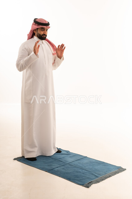 Saudi Man Performing Islamic Prayer on White Background