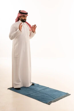 Saudi Man Performing Islamic Prayer on White Background