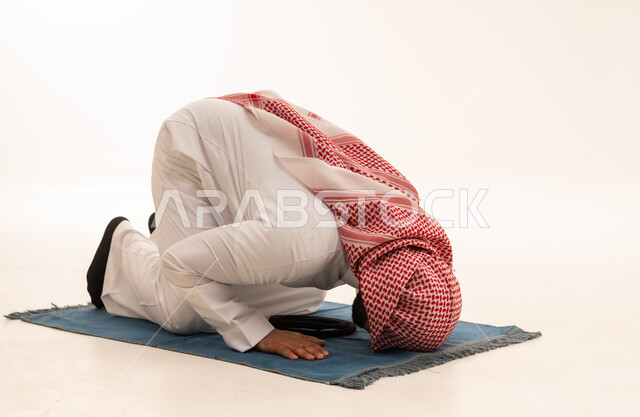 Saudi Man Performing Prayer Sujud on White Background