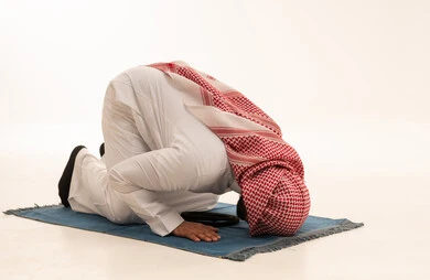 Saudi Man Performing Prayer Sujud on White Background