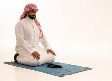 Saudi Man Praying Tashahhud on Blue Mat