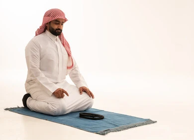 Saudi Man Performing Islamic Prayer in Tashahhud Position