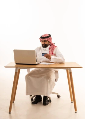 Saudi Man Online Shopping at Office Desk