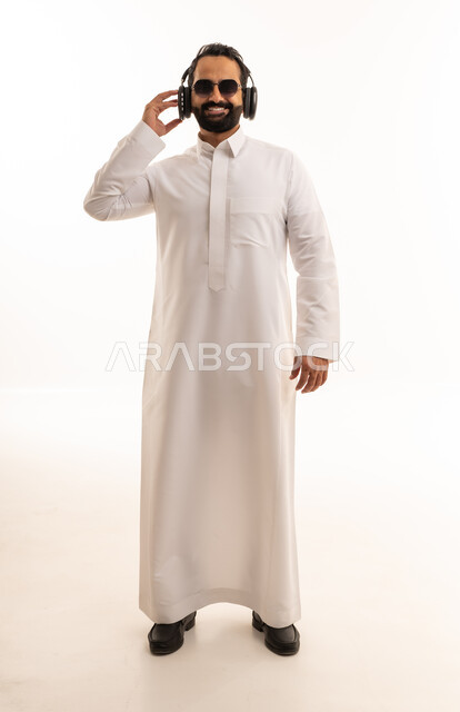 Saudi Man in White Thobe Wearing Headphones in Studio