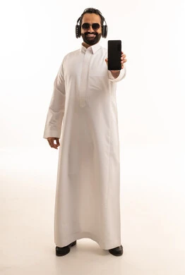 Saudi Man in Thobe with Smartphone and Headphones