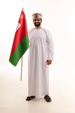 Omani Man in Traditional Dress Holding National Flag