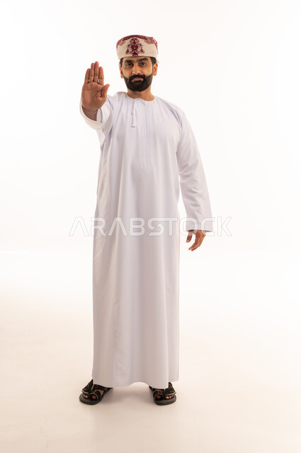 Omani Man in Traditional Dress Making Stop Gesture