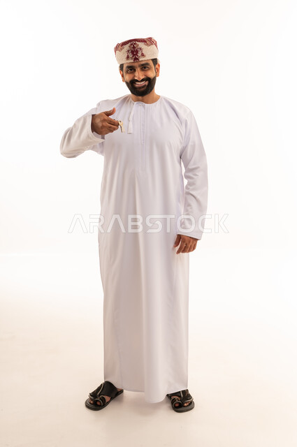 Omani Man in Traditional Dress Holding Car Key