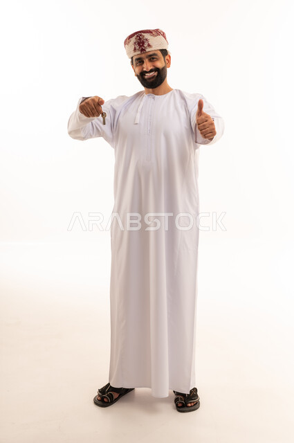 Omani Man Holding House Key and Thumbs Up