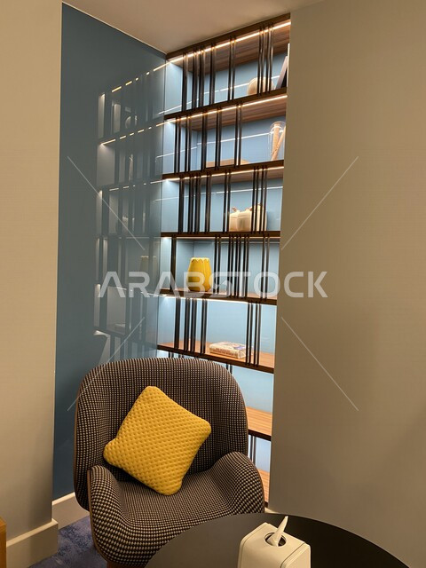 A picture of a sofa with a yellow cushion in one of the corners of the room, a sitting in a restaurant, home decorations, a quiet sitting