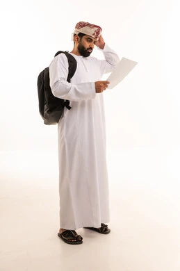 Omani Man with Backpack Looking Confused at Paper
