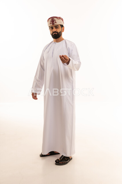 Omani Man in Traditional Dress with Hand Gesture - Photo