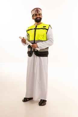 Omani Engineer in Safety Vest Holding Blueprints