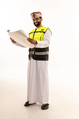 Omani Engineer Holding Construction Blueprint in Safety Vest