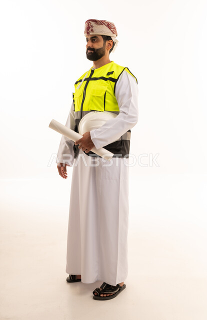 Omani Engineer in Safety Vest Holding Blueprints