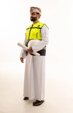 Omani Engineer in Safety Vest Holding Blueprints