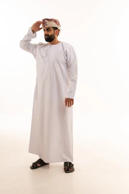 Omani Man in Traditional Dishdasha Giving Military Salute