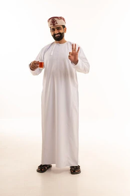 Omani Man in Traditional Dress with Tea