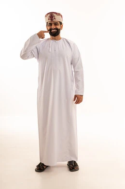 Omani Man in Traditional Dishdasha Pointing to Face