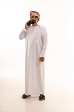 Omani Man in Traditional Dishdasha Talking on Phone