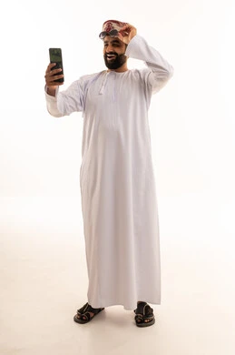 Omani Man in Traditional Dress Taking Smartphone Selfie