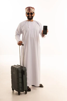 Omani Man with Suitcase and Smartphone in Studio