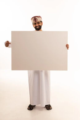 Omani Man in Traditional Dress Holding Blank Board