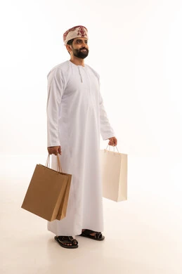 Omani Man with Shopping Bags in Traditional Dress