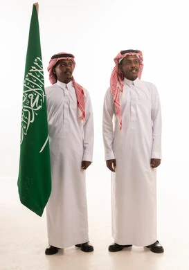 Saudi Men in Traditional Dress with National Flag