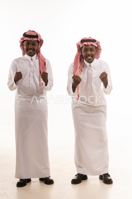 Two Saudi Men Celebrating Success in Studio