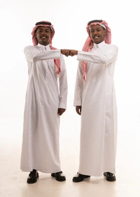 Saudi Men in Traditional Thobes Fist Bumping
