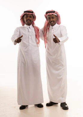 Saudi Men in Traditional Thobes Giving Thumbs Up