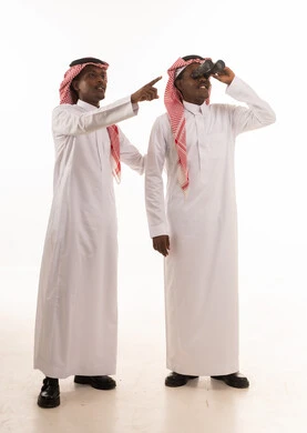 Saudi Men in Traditional Thobe Using Binoculars