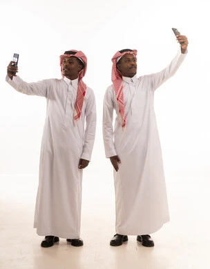 Saudi Men in Traditional Thobe Taking Selfies