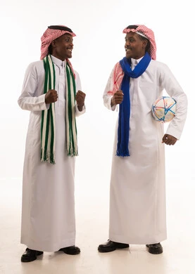 Saudi Men Celebrating Football Win in Traditional Thobes